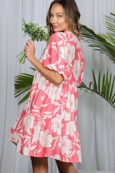 Pink floral babydoll mini dress with V-neckline, short puff sleeves, and tiered ruffle hem.