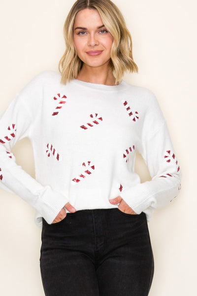 Crewneck Christmas sweater featuring all-over candy cane sequin accents.