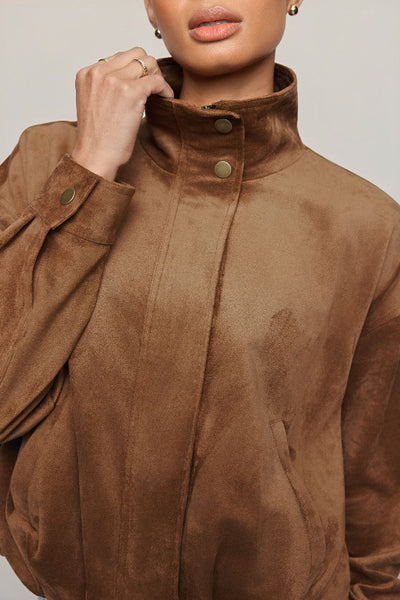 Close-up of Z Supply Corbin Bubble Hem Jacket in Saddle Suede showing the raised collar and welt pocket. Z Supply Corbin Bubble Hem Jacket; Z Supply Saddle Suede jacket; Z Supply ZJ263172; women's faux suede jacket; brown faux suede jacket; women's bubble hem jacket; cropped faux suede jacket; collared suede look jacket; women's jacket with welt pockets; long sleeve brown jacket.