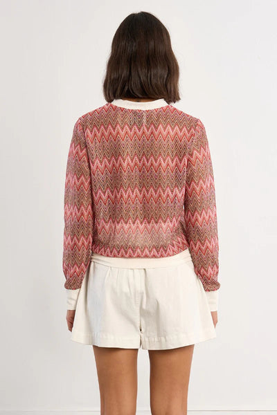 Multicolor chevron zigzag woven sweater with cream ribbed neckline and cuffs, straight fit, long sleeves — back view.