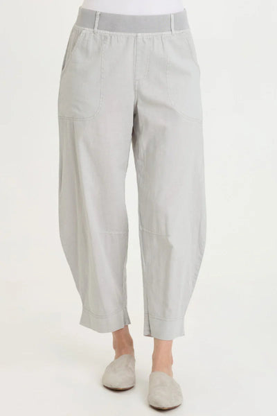Front view of Jisola Cotton Linen Barrel Pant in Light Cool Grey with cuffed hem, elastic jersey waistband, and front pockets, styled with grey slip-on flats.