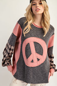 Mineral-washed thermal pullover with a large pink peace patch, plaid layered sleeves, and relaxed fit.