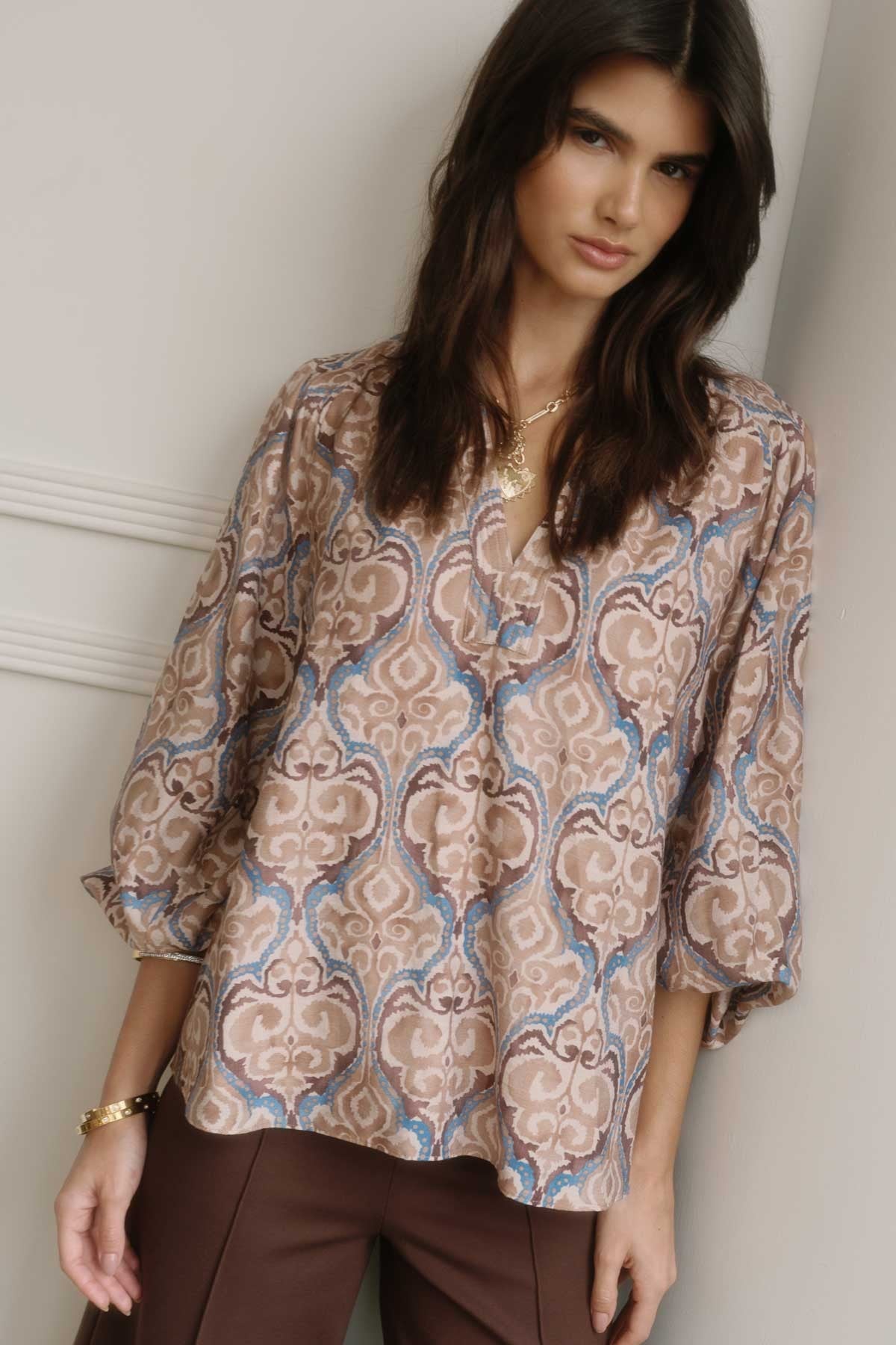 Paisley print blouse with V-neck and balloon sleeves.