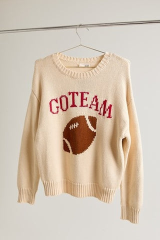 Cream knit sweater with Go Team football graphic.