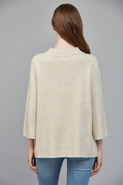 Back view of cream metallic sweater showing soft shimmer and draped silhouette.