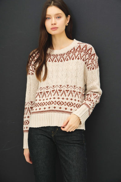 Cream and rust Fair Isle cable knit sweater with drop shoulders and a relaxed fit.