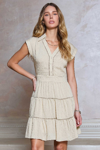 Tiered mini dress with shirt collar and button placket; natural color. V neck, mini length. 