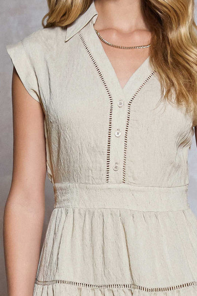 Tiered mini dress with shirt collar and button placket; natural color. V neck, mini length. 