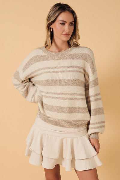 Front view of model in Sunday Edition neutral striped slouchy sweater with cream skirt;Sunday Edition neutral striped sweater
cream and taupe striped sweater
women’s slouchy crewneck sweater
relaxed fit striped knit sweater
drop-shoulder sweater for women
cozy neutral pullover sweater
cream striped sweater for fall
women’s soft knit striped sweater
casual striped sweater with ribbed hem
neutral sweater to wear with jeans