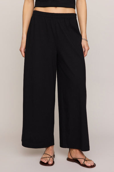  Z Supply Scout Jersey Crop Flare Pant in black - front view, high-rise elastic waistband, wide-leg silhouette, 100% cotton jersey.

