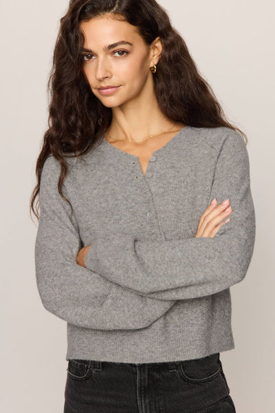 Gray Z Supply Westmont Henley Sweater showing the Henley neckline, long sleeves, and shorter hem. Z Supply Westmont Henley Sweater; Z Supply ZW264787; women's gray Henley sweater; women's button placket sweater; long sleeve knit Henley; cozy gray knit pullover; women's raglan sleeve sweater; cropped Henley sweater; relaxed fit Henley sweater; Z Supply women's knitwear.