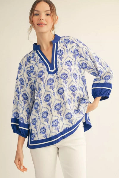 Model is wearing 3/4 Puff Sleeve Boho Print Top with contrast detail - front view showing blue and white floral print, V-neckline with striped trim, and romantic puff sleeves