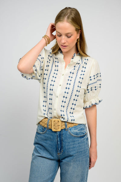 Embroidered Puff Sleeve Button Front Blouse ivory - front view showing delicate blue embroidery, button-front closure, and feminine puff sleeves styled with jeans.