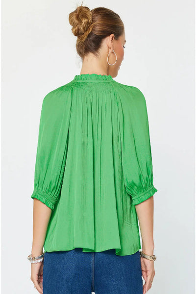 Angelica Kelly green pleated pullover top with ruffle-trimmed neckline and pleated back detail, back view.