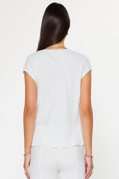 White cowl neck cap sleeve top with soft draped neckline and relaxed fit, back view.