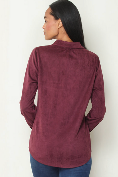 Back view of model wearing Black Cherry faux suede long-sleeve shirt with smooth brushed finish and curved hem;Black Cherry faux suede shirt; Paparazzi faux suede button-front shirt; women’s Western-inspired button-down; burgundy faux suede shirt women; long-sleeve faux suede shirt; soft suede-look button-up shirt; Black Cherry Western shirt women; women’s faux suede shirt with collar; button-front shirt to wear with jeans.