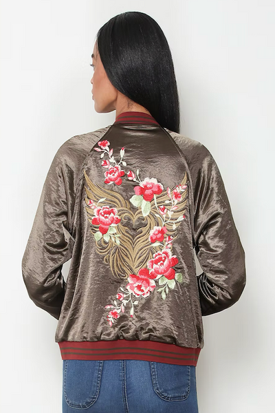 Back view of olive satin reversible bomber jacket with large pink floral embroidery;reversible satin bomber jacket women; burgundy quilted bomber jacket; olive satin bomber jacket; floral embroidered bomber jacket; Paparazzi reversible jacket; women’s burgundy satin jacket; olive floral jacket women; lightweight reversible bomber jacket; vintage-inspired floral bomber jacket.