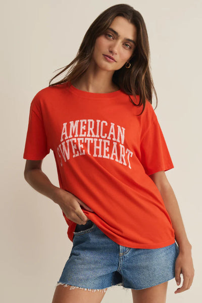 Model is wearing a relaxed-fit red American Sweetheart boyfriend tee with distressed varsity-font lettering in 100% cotton jersey, front view.