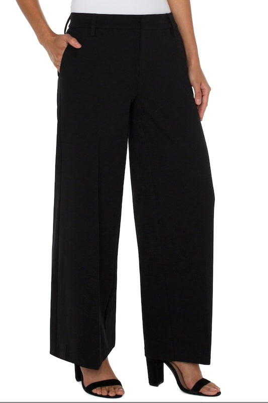 High-rise black wide-leg Kelsey trousers with front pockets and smooth waistband.