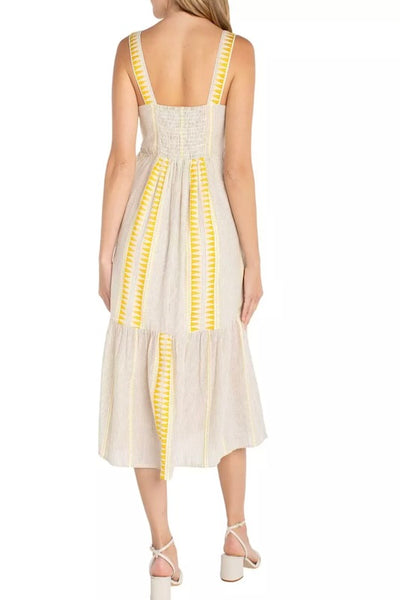 Sleeveless tiered midi dress in a cream and brown neutral stripe print, back view on model styled with strappy heeled sandals.