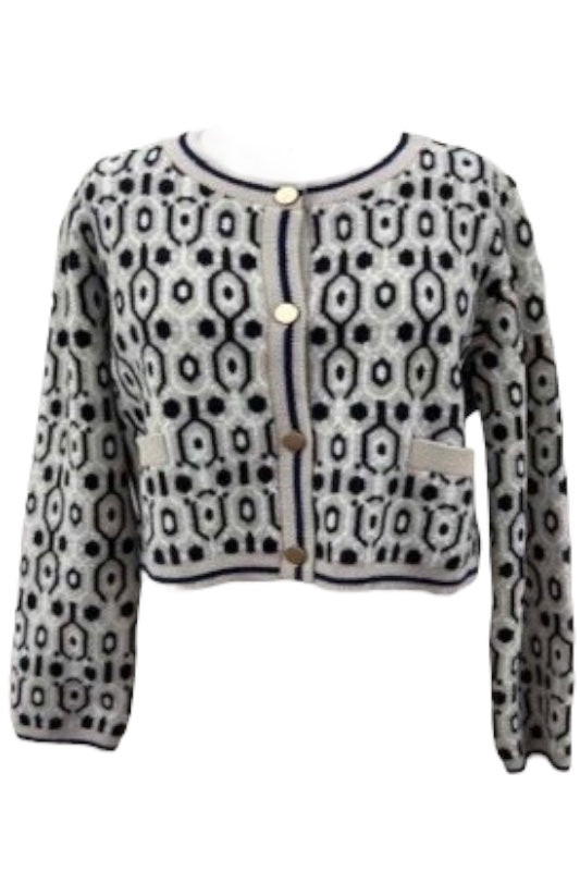 Cropped abstract knit cardigan with black and taupe geometric pattern, gold buttons, and contrast pocket details.