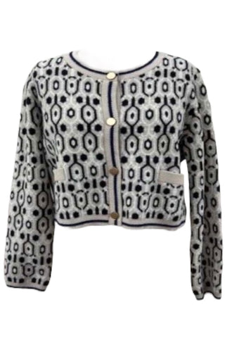 Cropped abstract knit cardigan with black and taupe geometric pattern, gold buttons, and contrast pocket details.