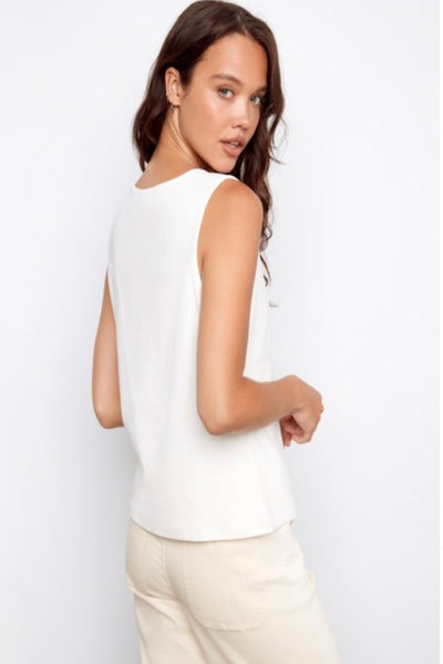 White sleeveless top featuring a delightful heart crochet patch pocket that adds instant personality.