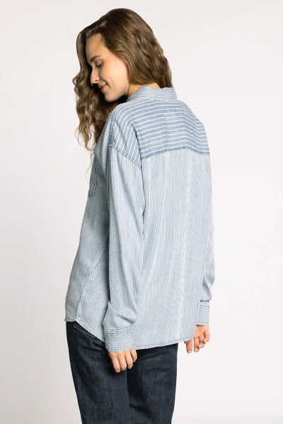 Thread & Supply Helena Shirt in multi pinstripe blue and white pattern, relaxed fit button-down with dropped shoulders and chest pocket, styled with dark denim jeans