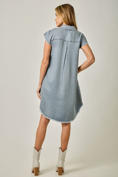 Flutter Sleeve Tencel Shirt Dress with Fringe Hem in light denim blue, back view - sleeves, hi-lo silhouette, and fringe hem with white boots.
