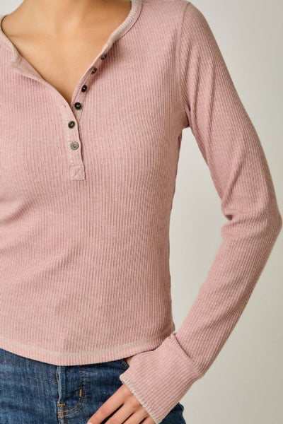 Close-up of the Mystree vintage rose Henley top showing ribbed texture, neckline buttons, blanket-stitch accents, and extended cuffs.Mystree vintage rose Henley top; women's blanket stitch Henley; vintage rose long sleeve top; ribbed Henley top for women; women's top with thumb holes; Mystree 71262 top; pink ribbed long sleeve shirt; blanket stitch knit top; women's hi-lo hem top; stretchy long sleeve layering top.