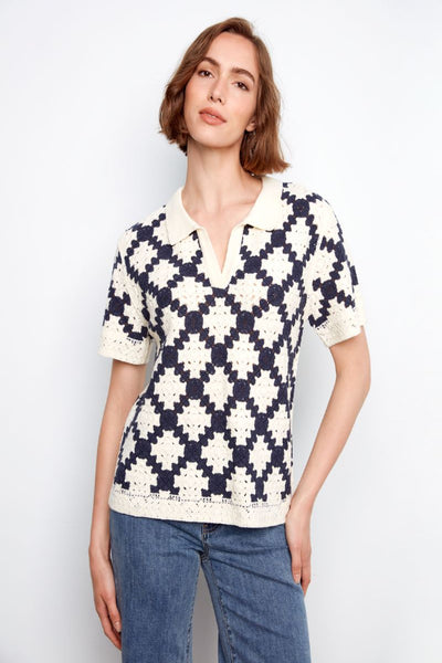 Navy and cream geometric crochet top with polo collar on model.
