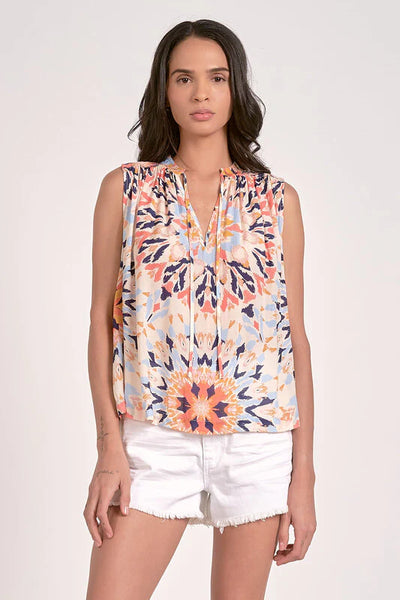 Sleeveless multi-color kaleidoscope floral top with flowy fit and ruffled V-neck.