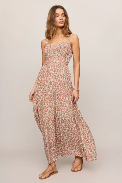 Model is wearing a floral dress with flat sandals, front view.