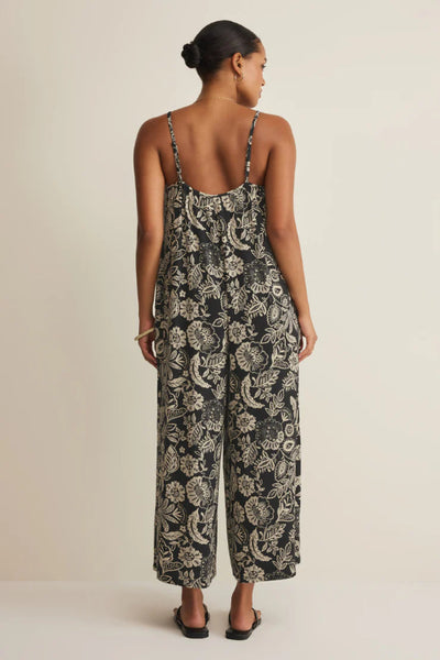Black Day Off Luz floral print sleeveless jumpsuit with ruffle scoop neckline, adjustable spaghetti straps, and wide straight leg, back view.