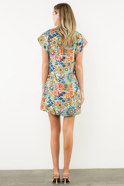 Back view of full colorful pattern and relaxed fit of woven dress.