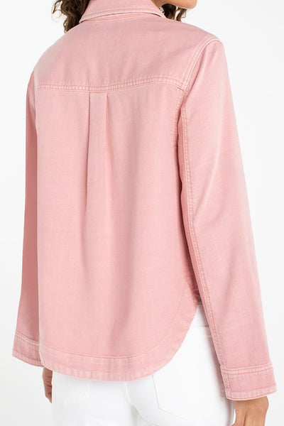 Misty blush pink high-low denim shacket with button front and curved hem, back view, paired with white jeans.