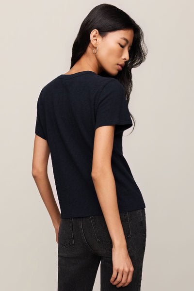 Model is wearing a black t-shirt and dark jeans, back/side view
