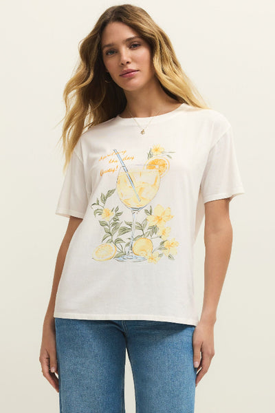 White Spritz Boyfriend Tee with yellow lemon graphic and 'Squeeze the Day Away' script, styled with blue jeans in relaxed fit.