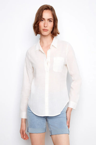 White 100% cotton long sleeve button-front shirt with classic collar, chest pocket, and adjustable roll-up sleeves, styled with denim shorts, front view.