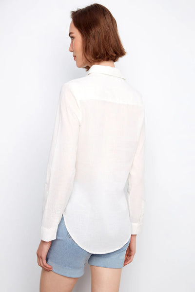 white 100% cotton long sleeve button-front shirt with classic collar, chest pocket, and adjustable roll-up sleeves, styled with denim shorts, back view.