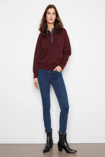 Model wearing Charlie B merlot denim trim polo sweater with blue jeans and black ankle boots. Charlie B denim trim polo sweater; Charlie B merlot sweater; women’s merlot polo sweater; denim collar sweater women; burgundy sweater with denim collar; women’s snap placket sweater; relaxed fit polo sweater women; long sleeve collared knit sweater; women’s drop shoulder sweater; Charlie B fall knitwear.
