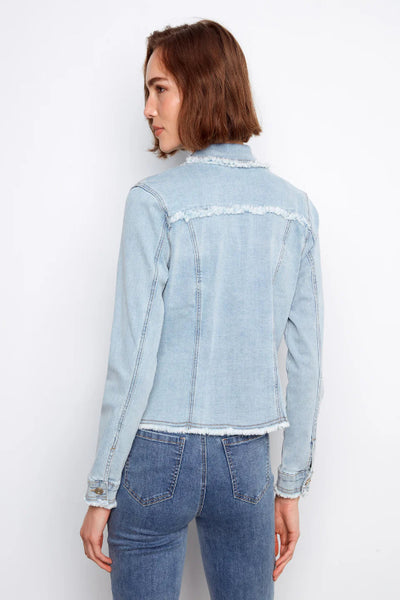 Bleach blue stretch denim jacket with frayed edges, and long sleeves, styled with blue jeans, back view.