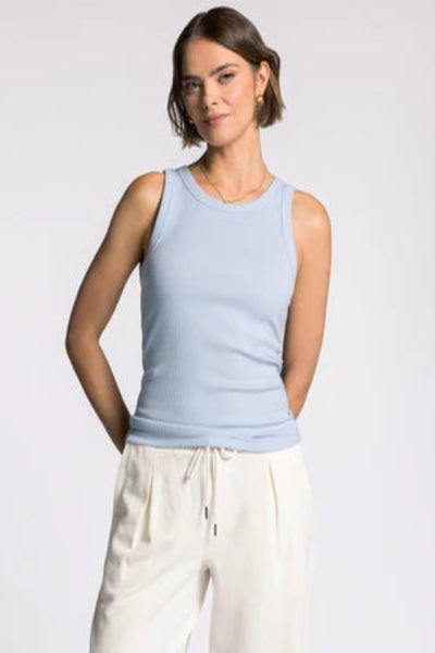 Powder blue Edlin Tank sleeveless crew neck top with white drawstring pants, front view showing fitted silhouette and classic neckline.