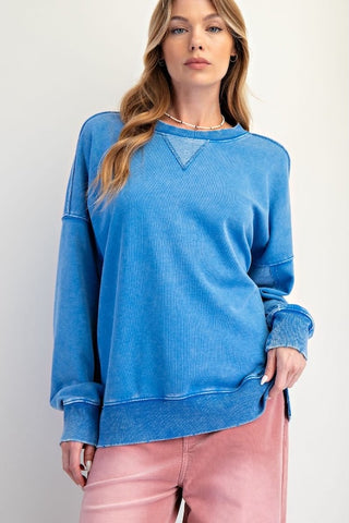 Blue mineral washed terry pullover with crew neckline, triangle stitch detail, and long sleeves.