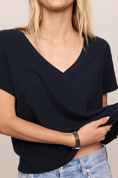 Nomad V Neck Tee in navy, a relaxed V-neck short sleeve tee in 100% cotton brushed slub jersey, styled with light wash wide-leg jeans — front view.