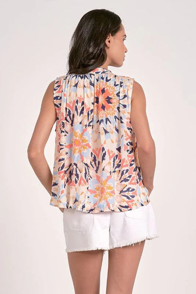 “Back view of the flowy sleeveless kaleidoscope print blouse in pastel tones”
