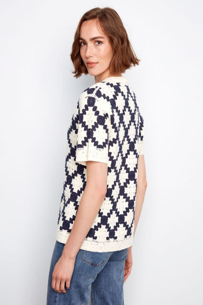 Navy and cream geometric crochet top with polo collar on model.