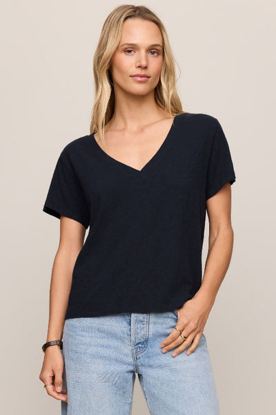 Nomad V Neck Tee in navy, a relaxed V-neck short sleeve tee in 100% cotton brushed slub jersey, styled with light wash wide-leg jeans — front view.