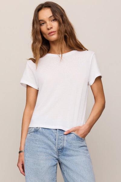 Model wearing a white t-shirt and light blue jeans.