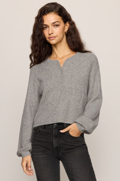 Front view of gray Z Supply Westmont Henley Sweater with long sleeves, styled with black jeans. Z Supply Westmont Henley Sweater; Z Supply ZW264787; women's gray Henley sweater; women's button placket sweater; long sleeve knit Henley; cozy gray knit pullover; women's raglan sleeve sweater; cropped Henley sweater; relaxed fit Henley sweater; Z Supply women's knitwear.
